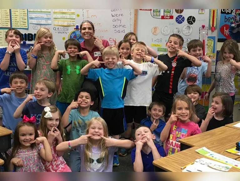 Team members and kids at dental education event