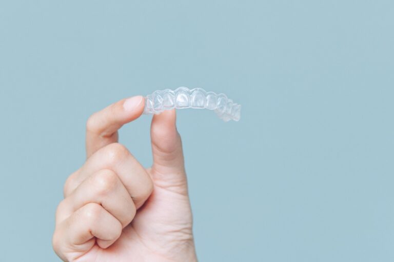 hand holding Invisalign tray