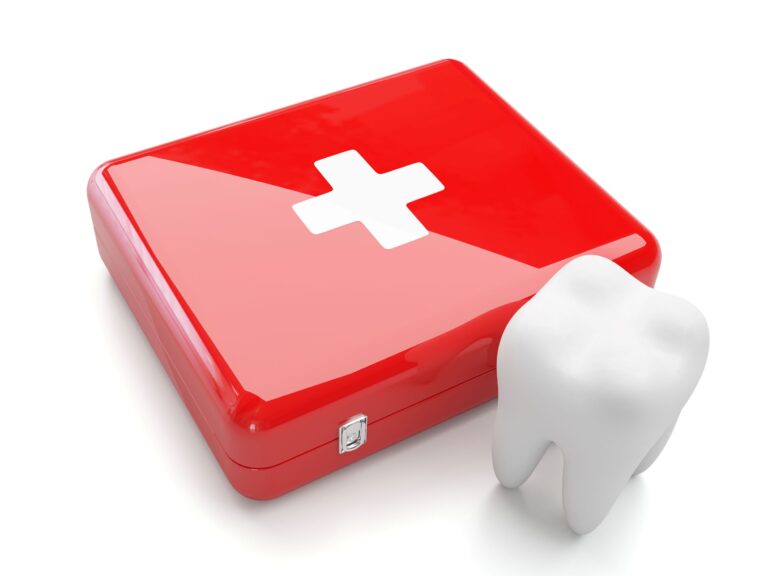 A red case with a white cross next to a large model tooth on a white surface