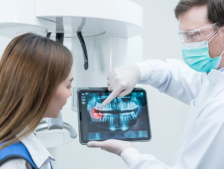 Dentist looking at dental x-rays
