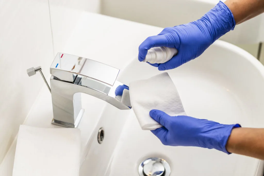 A dentist disinfects a surface.